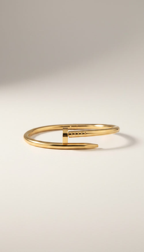 KM Jewelry Co. 18K gold-plated stainless steel bangle with iconic nail design. Elegant and durable.