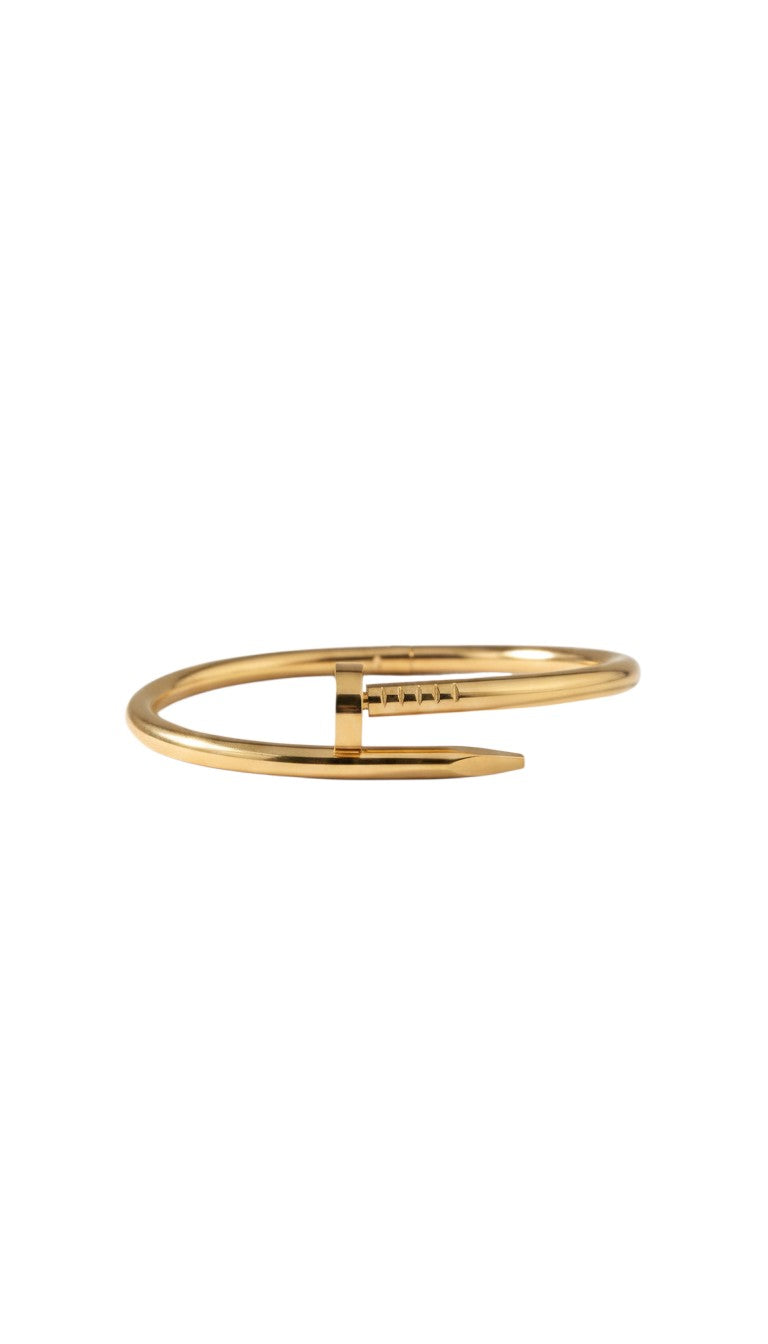 KM Jewelry Co. 18K gold-plated stainless steel bangle with iconic nail design and engraved details.