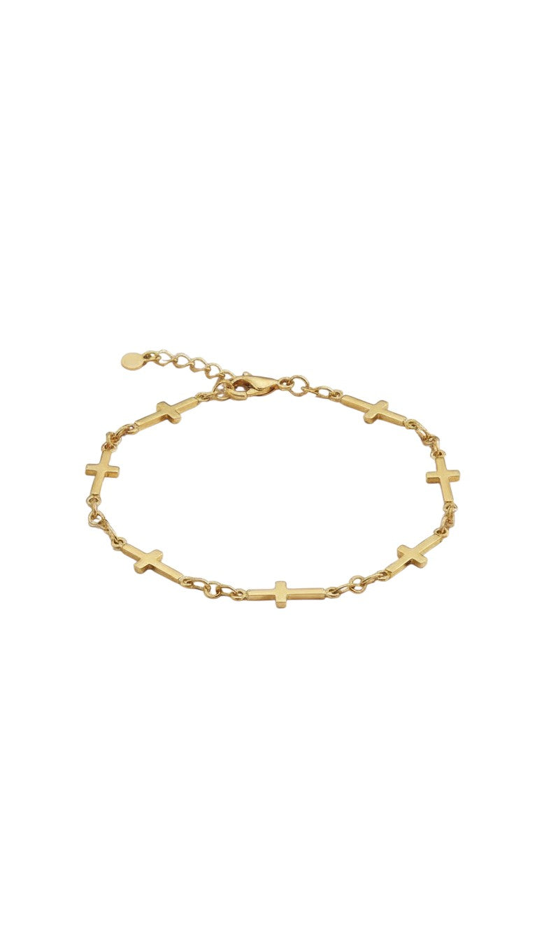 KM Jewelry Co. delicate gold cross chain bracelet in 18k gold PVD stainless steel, faith-inspired detail.