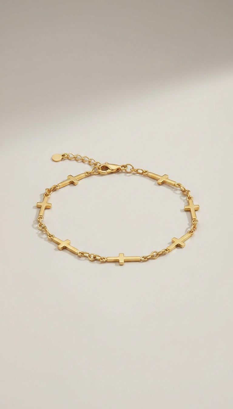 KM Jewelry Co. 18k gold PVD stainless steel cross chain bracelet with delicate faith-inspired detail.