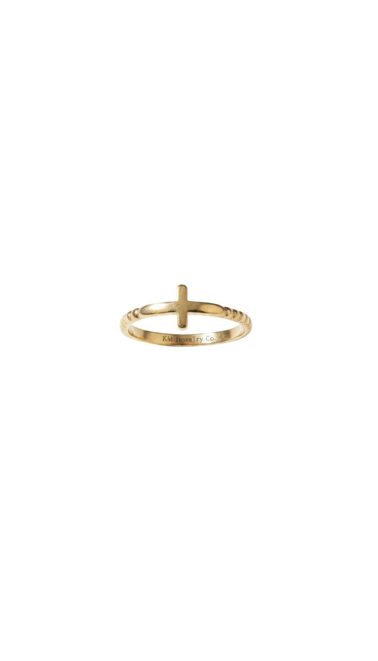 KM Jewelry Co. gold ring with a cross detail, made of 18K gold PVD stainless steel. Features a beaded band.