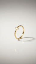 KM Jewelry Co. gold ring with cross detail, 18K gold PVD stainless steel, beaded band.