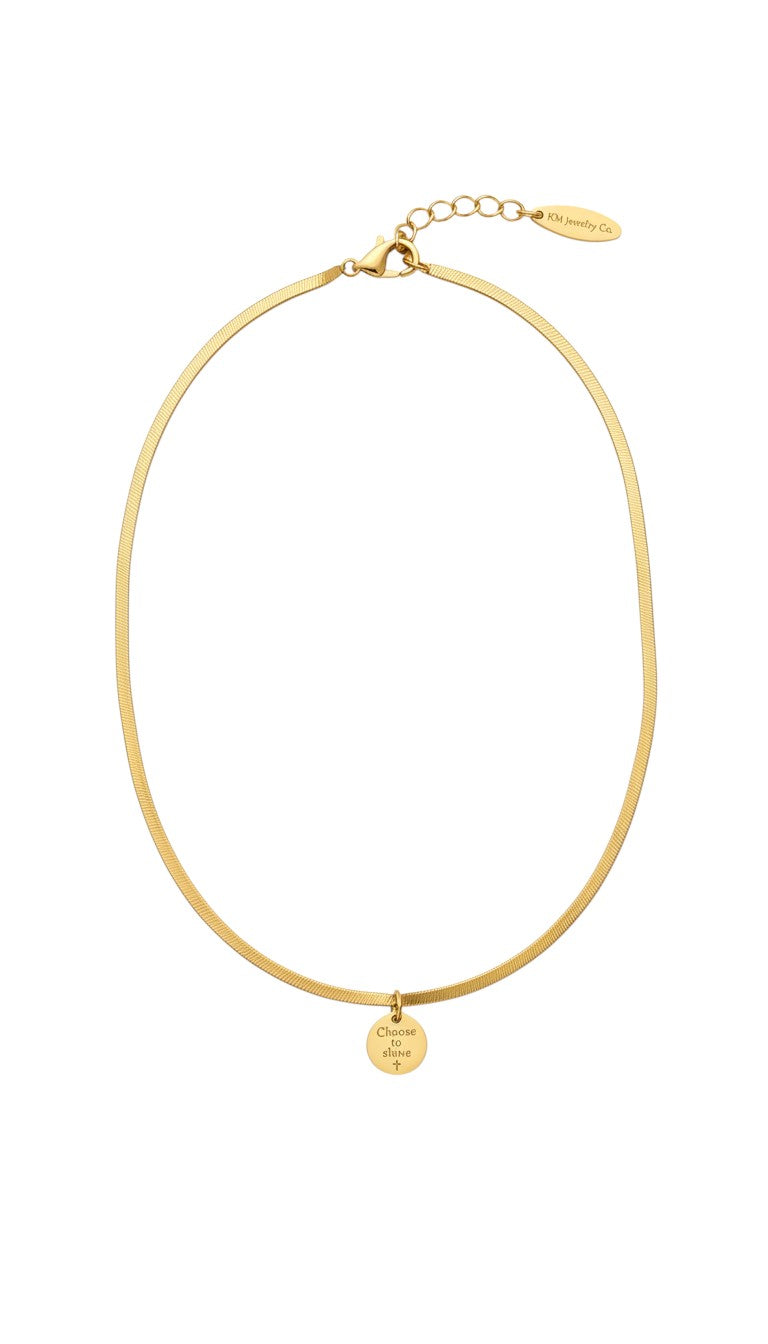 KM Jewelry Co. 18K gold PVD stainless steel herringbone chain necklace on a model.