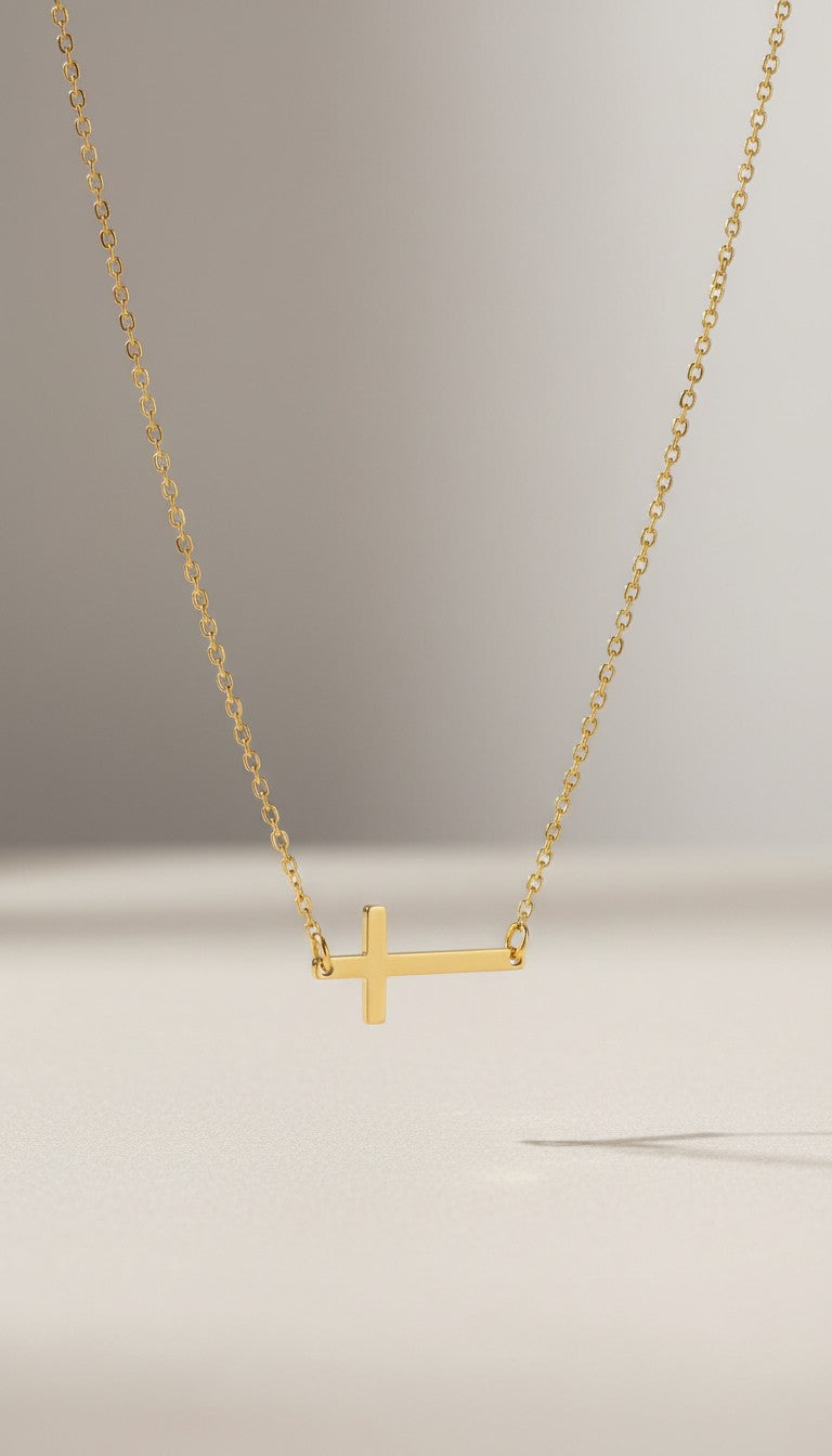 KM Jewelry Co. polished horizontal cross necklace in 18k gold PVD stainless steel. Faith-inspired accent.