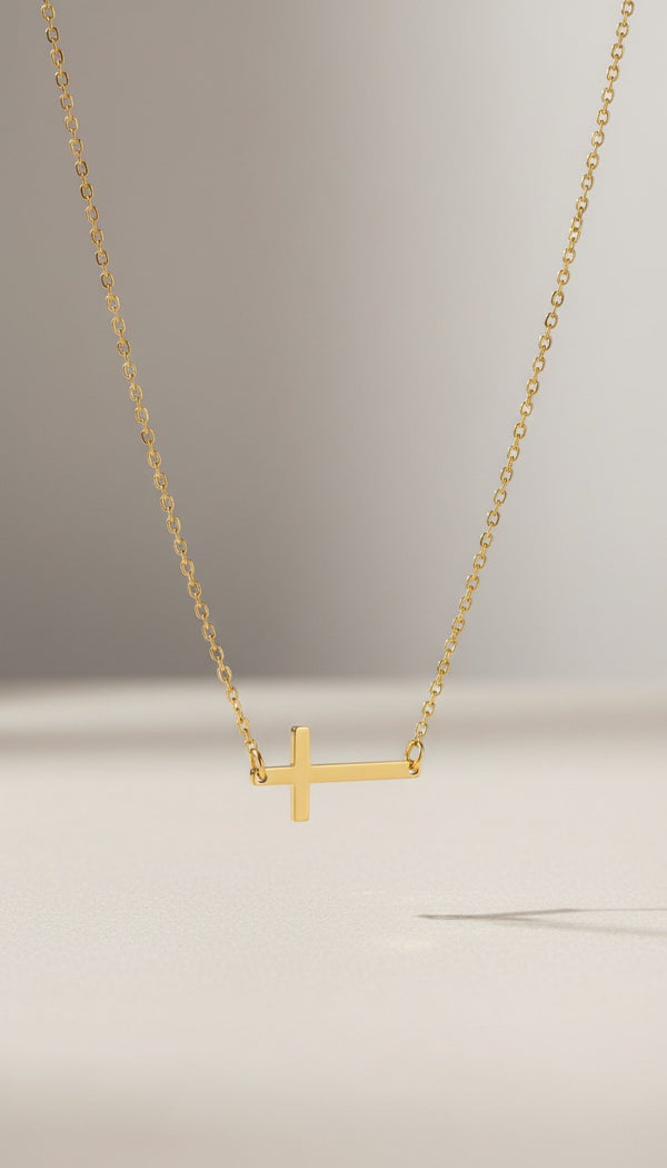 KM Jewelry Co. polished horizontal cross necklace in 18k gold PVD stainless steel. Faith-inspired accent.