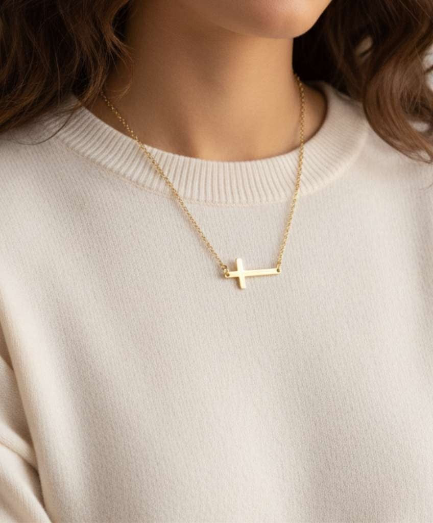KM Jewelry Co. polished horizontal cross necklace in 18k gold PVD stainless steel, a faith-inspired accent.