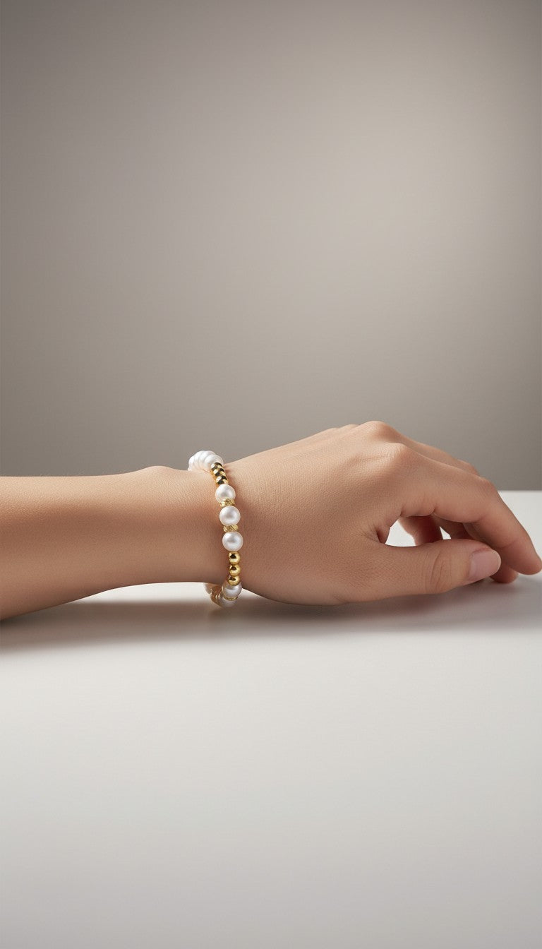 KM Jewelry Co. stretch bracelet with 8mm glass pearls and 18K gold PVD accents.