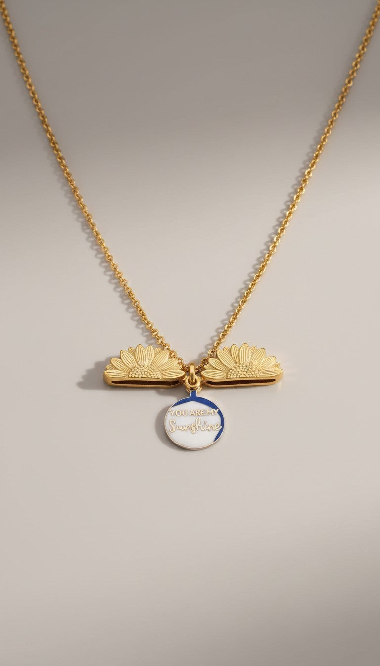 KM Jewelry Co. 18K PVD gold necklace with two sunflower charms and a round pendant that says "You are my Sunshine."