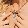 KM Jewelry Co. 18K PVD gold necklace with two open sunflower charms and a white pendant reading "You are my Sunshine".